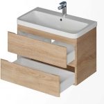 Wooden bathroom vanity with a white rectangular sink and three open drawers.