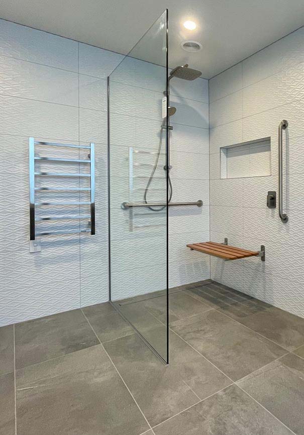 Accessible wetroom with shower seat and grab bars