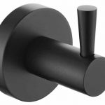 Wall-mounted dark metal coat or towel hook with a circular base and a short cylindrical hook projecting outward.